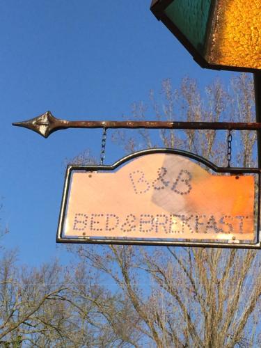 a street sign hanging from a traffic light at Prà de Mandè in Viano