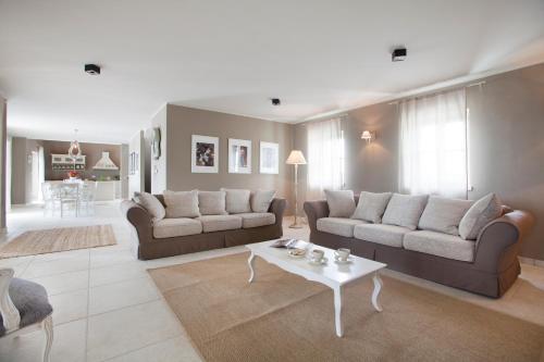 a living room with two couches and a coffee table at Villa Sara in Vižinada