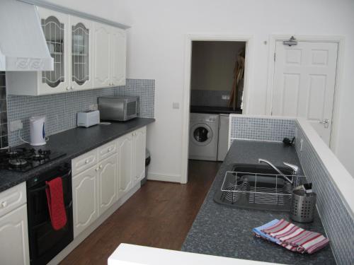 a kitchen with a sink and a dishwasher at Litton Mill Apartment in Tideswell