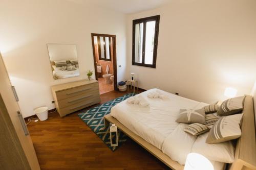 モンデッロにあるLuminHouse Mondello Limoneのベッドルーム(大型ベッド1台、鏡付)