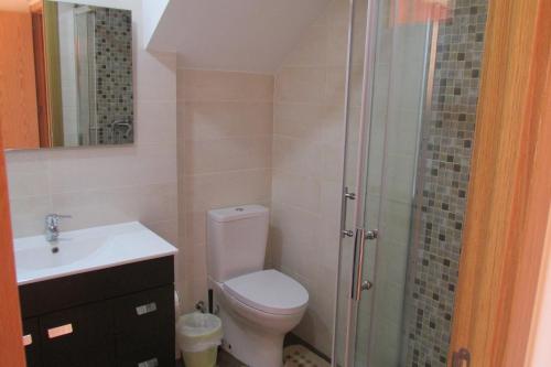 a bathroom with a toilet and a sink and a shower at Residencial Marialva Park in Corroios