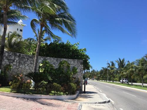 a street with palm trees on the side of a road at Cancun Plaza - Best Beach in Cancún