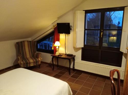 Postel nebo postele na pokoji v ubytování Hotel Rural El Pagadín