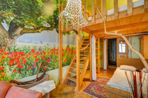 a room with a staircase in a house with flowers at ARTHARMONY Pension & Hostel in Prague