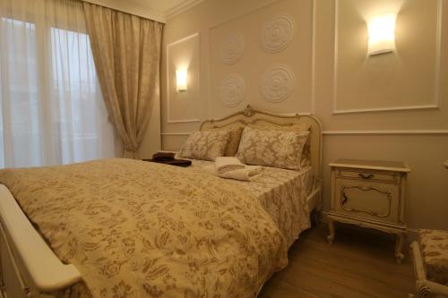 a bedroom with a bed with a phone on it at Luxurious Athenian Apartment in Athens