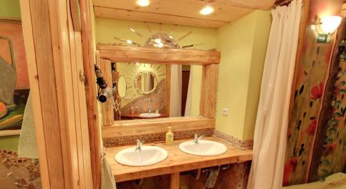 a bathroom with a mirror and a sink at Artharmony Pension & Hostel in Prague