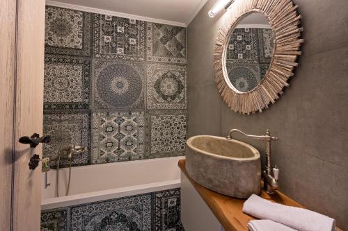 a bathroom with a sink and a mirror at Patriko House in Plakias