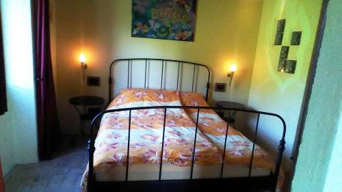 a bed in a bedroom with a bedspread on it at Agriturismo Carincone in Pergola