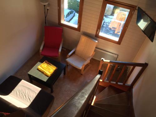 an overhead view of a living room with a couch and chairs at Appartement Duplex in Luchon
