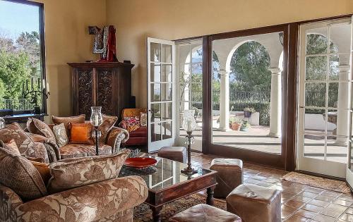 a living room with a couch and a glass table at The Patrician Hollywood Universal in Pasadena