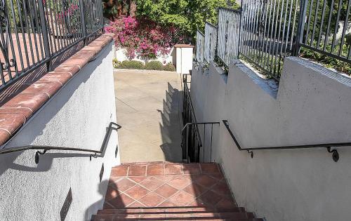a set of stairs with a wrought iron fence at The Patrician Hollywood Universal in Pasadena