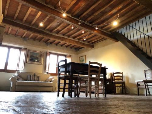 a living room with a table and chairs at Il Nido sulla Ruga in Anghiari