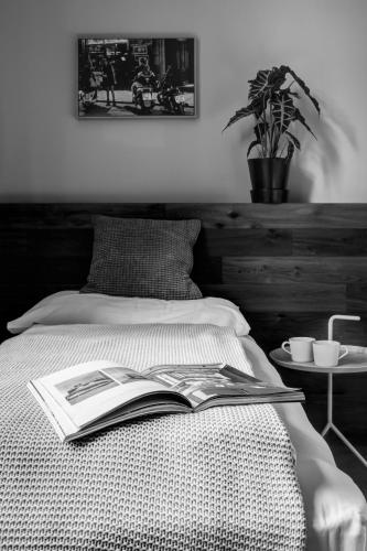 a book laying on a bed with a table at Hotel city.city in Ostrava