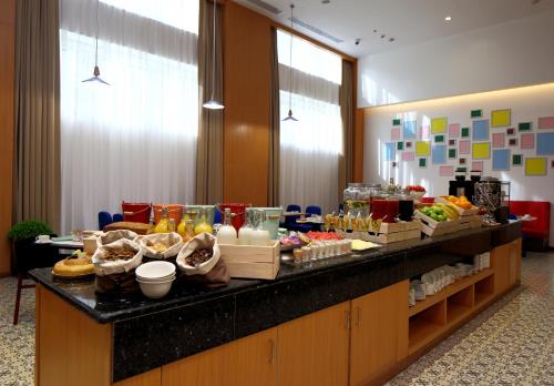 a buffet line in a hotel with food on it at Park Inn by Radisson Najran in Najran