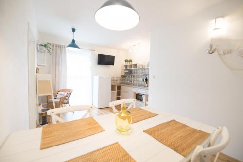 a kitchen and dining room with a table and chairs at Apartmány Lea in Liptovský Mikuláš