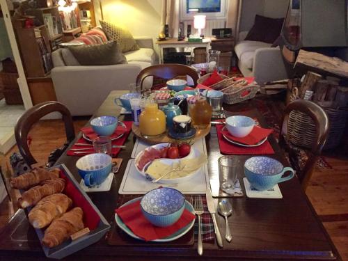 a dining room table with food on it at Vingt Vieux Bourg in Rochefort-en-Terre