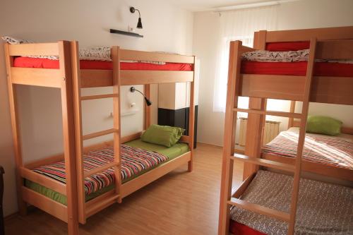 a room with two bunk beds and a room with at Hostel Vrba in Ljubljana