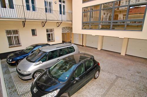 three cars parked in a parking lot in front of a building at Ai Quattro Angeli in Prague