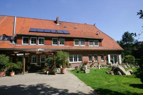 a red brick house with solar panels on the roof at Garbers-Hof in Undeloh