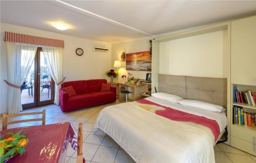 a bedroom with a bed and a red couch at Il Giardino dei Gigli in Meta