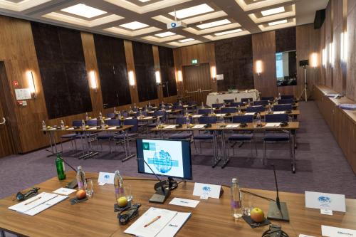 a large room with tables and chairs and a television at Atlantida Boutique Hotel in Rogaška Slatina