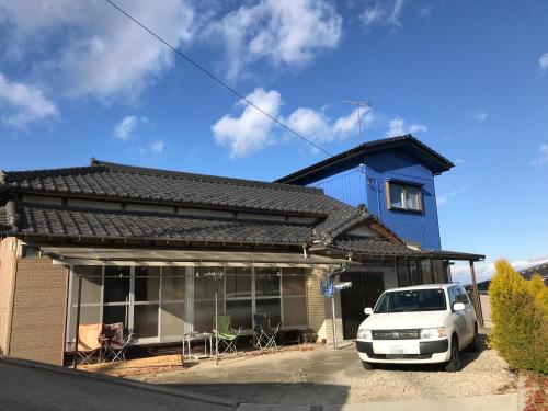 a white car parked in front of a house at Traveler's Wharf Shichigahama in Shichigahama