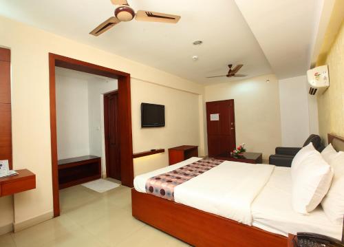 a hotel room with a bed and a couch at Trichur Towers in Trichūr