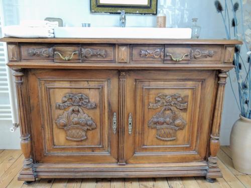 a wooden cabinet with a sink in a bathroom at L'ANCIENNE FORGE in Gaillac-dʼAveyron
