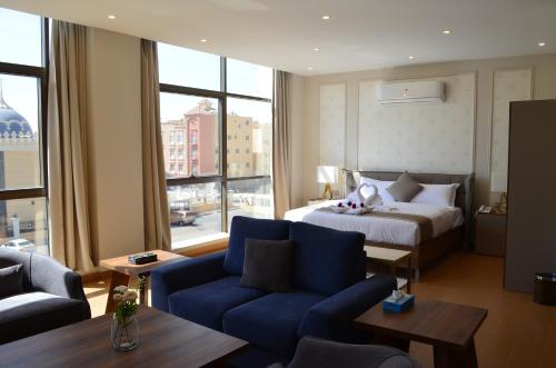 une chambre d'hôtel avec un lit et une grande fenêtre dans l'établissement Larissa Suites, à Khobar