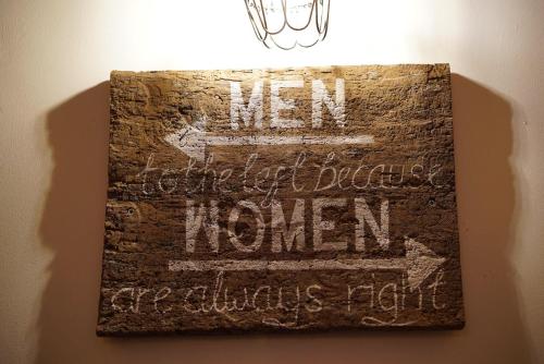 a sign on a wall that says men cannot tolerate women at The Horseshoe Inn in Crickhowell