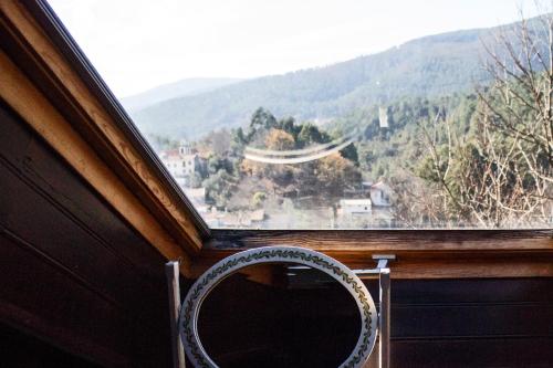 a mirror sitting in front of a window with a view at Casa do Coentral a sua casa Rustica in Lousa