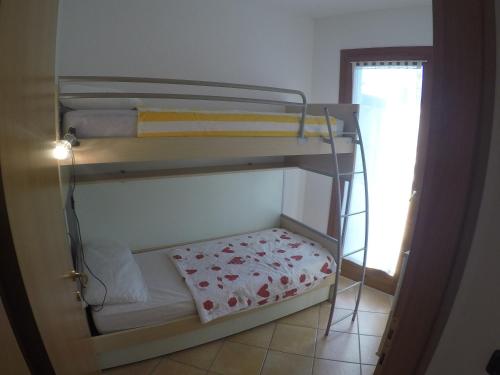 a room with two bunk beds in a room at Residence Marina Blu - Agenzia Cocal in Caorle