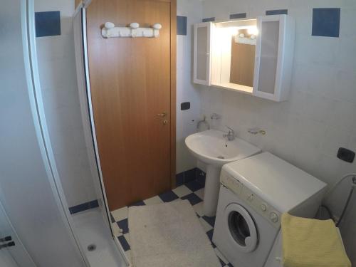 a bathroom with a washing machine and a sink at Residence Marina Blu - Agenzia Cocal in Caorle