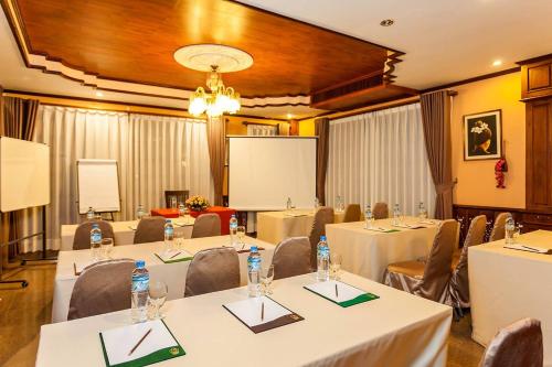 a conference room with tables and chairs and a podium at Chandara Boutique Hotel in Vientiane