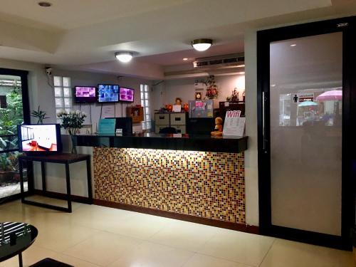 a restaurant with a counter in a room at Double DD House at MRT Sutthisarn in Bangkok