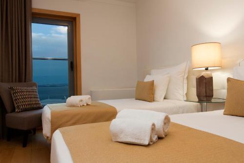 a hotel room with two beds and a window at Oriente 57 Apartments by APT IIN - Parque das Nações in Lisbon
