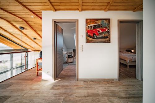 an open hallway with a red truck painting on the wall at Ferienhaus "Chalet100" in Löbnitz
