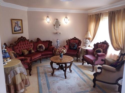 a living room with red furniture and a table at 110 Bay View in Brenton-on-Sea