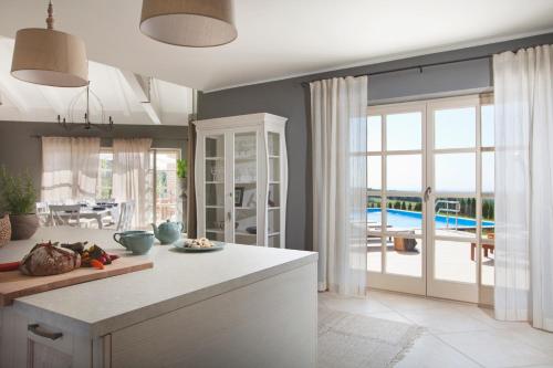 a kitchen with a table and a view of a pool at Villa Star in Vižinada