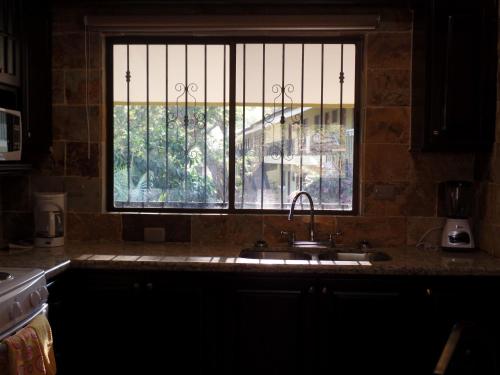 a kitchen with a sink and a window at Sweet Dreams in Coco