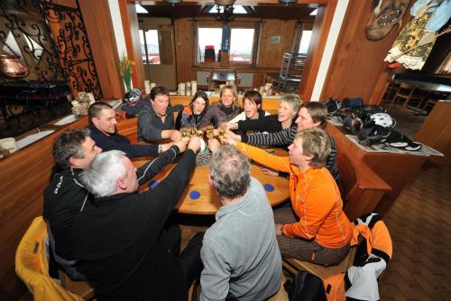 a group of people sitting around a table at Hotel Sparrhorn in Belalp