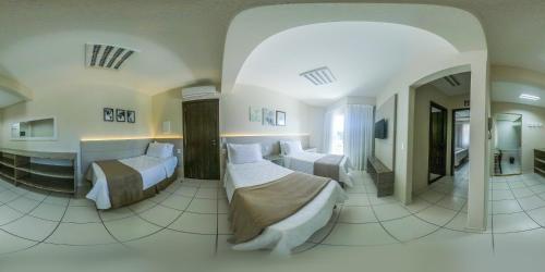 a bedroom with two beds in a room at Pousada Doluar in Penha