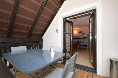 a dining room with a table and chairs at Pod Strzechą in Darłowo