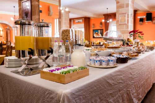 a table with a buffet of food and drinks at Hotel Salento in Specchia