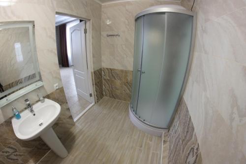 a bathroom with a shower and a sink at Гостевой дом НИК in Kharkiv