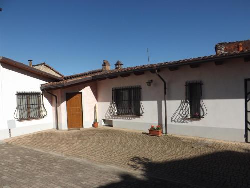 a white house with black windows and a door at Domus Amica in Lu