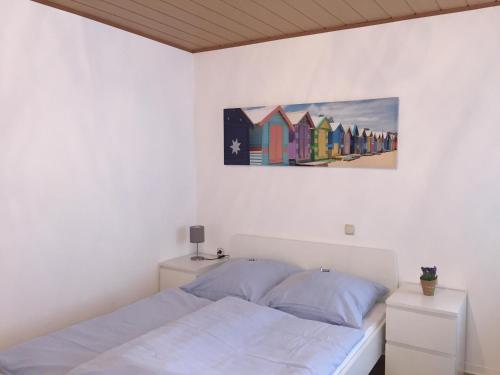 a bedroom with a bed and a painting on the wall at Pension Lindenhof in Limburg an der Lahn
