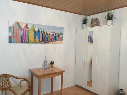 a room with a table and a painting on the wall at Pension Lindenhof in Limburg an der Lahn