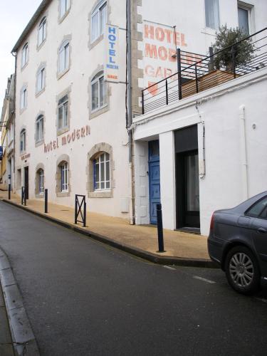 a car parked in front of a building on a street at Hôtel Modern in Concarneau