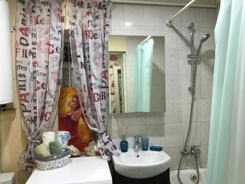 a bathroom with a sink and a shower curtain at Holiday house near sea on Lvovskaya in Odesa